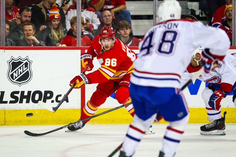 Oct 22, 2025; Calgary, Alberta, CAN; Calgary Flames left wing Joel Farabee (86) passes the puck against the Montreal Canadiens during the second period at Scotiabank Saddledome. Mandatory Credit: Sergei Belski-Imagn Images