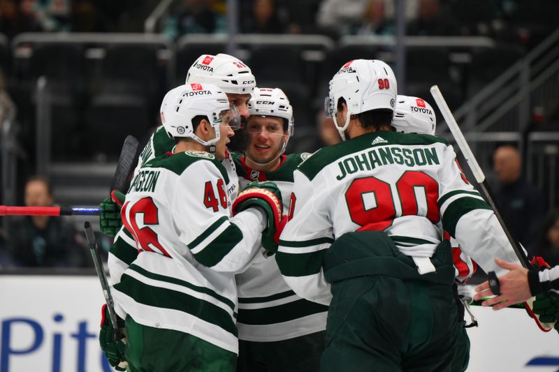 Dec 10, 2023; Seattle, Washington, USA; The Minnesota Wild celebrate after Minnesota Wild center Marco Rossi (23) scored a goal against the Seattle Kraken during the third period at Climate Pledge Arena. Mandatory Credit: Steven Bisig-USA TODAY Sports