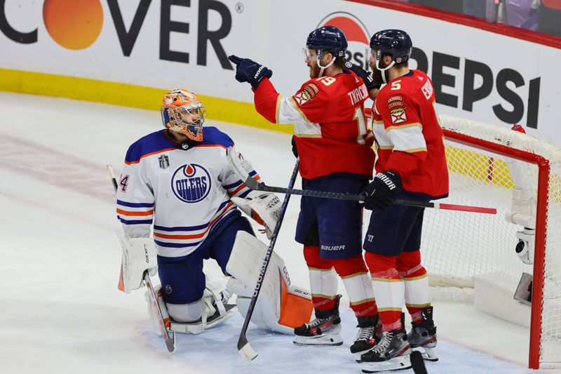 Jun 18, 2024; Sunrise, Florida, USA; Florida Panthers forward Matthew Tkachuk (19) celebrates scoring against Edmonton Oilers goaltender Skinner Stuart (74) with defenseman Aaron Ekblad (5) during the second period in game five of the 2024 Stanley Cup Final at Amerant Bank Arena. Mandatory Credit: Sam Navarro-USA TODAY Sports