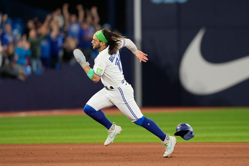 Sep 8, 2023; Toronto, Ontario, CAN; Toronto Blue Jays shortstop Bo Bichette (11) heads for home plate on a double hit by Toronto Blue Jays first baseman Vladimir Guerrero Jr. (not pictured) during the seventh inning against the Kansas City Royals at Rogers Centre. Mandatory Credit: John E. Sokolowski-USA TODAY Sports