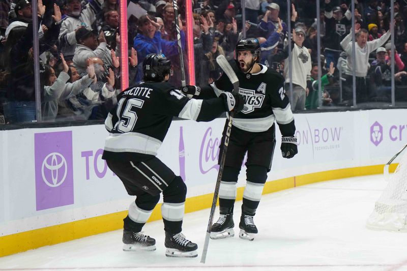 Nov 27, 2024; Los Angeles, California, USA; LA Kings center Phillip Danault (24) and center Alex Turcotte (15) celebrate after a goal against the Winnipeg Jets in the second period at Crypto.com Arena. Mandatory Credit: Kirby Lee-Imagn Images