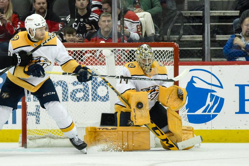 Apr 7, 2024; Newark, New Jersey, USA; Nashville Predators goaltender Juuse Saros (74) makes a save against the New Jersey Devils during the third period at Prudential Center. Mandatory Credit: John Jones-USA TODAY Sports