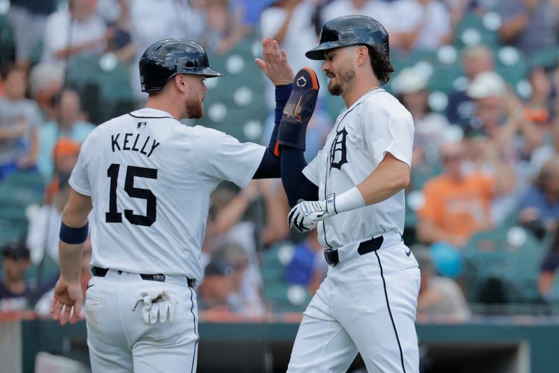 Jul 11, 2024; Detroit, Michigan, USA;  Detroit Tigers catcher Carson Kelly (15) and Detroit Tigers shortstop Zach McKinstry (39) congratulate each other after scoring in the sixth inning against the Cleveland Guardians at Comerica Park. Mandatory Credit: Rick Osentoski-USA TODAY Sports