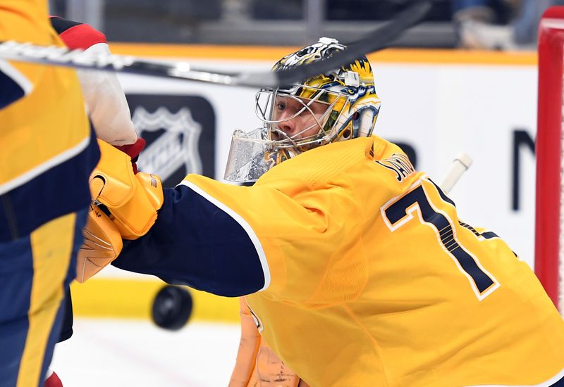 Jan 26, 2023; Nashville, Tennessee, USA; Nashville Predators goaltender Juuse Saros (74) makes a save during the second period against the New Jersey Devils at Bridgestone Arena. Mandatory Credit: Christopher Hanewinckel-USA TODAY Sports