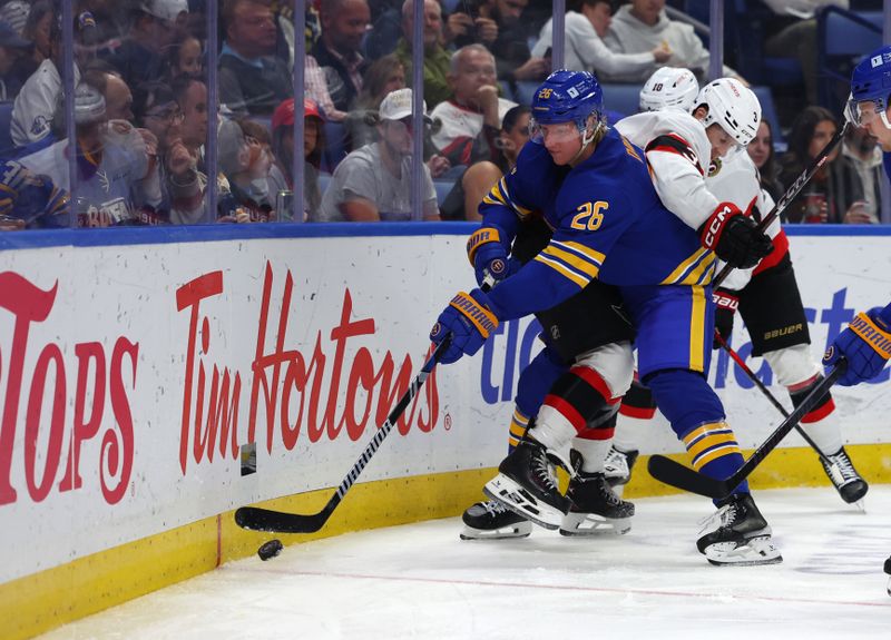 Nov 5, 2024; Buffalo, New York, USA;  Buffalo Sabres defenseman Rasmus Dahlin (26) clears the puck along the boards as Ottawa Senators defenseman Nick Jensen (3) tries to defend during the third period at KeyBank Center. Mandatory Credit: Timothy T. Ludwig-Imagn Images