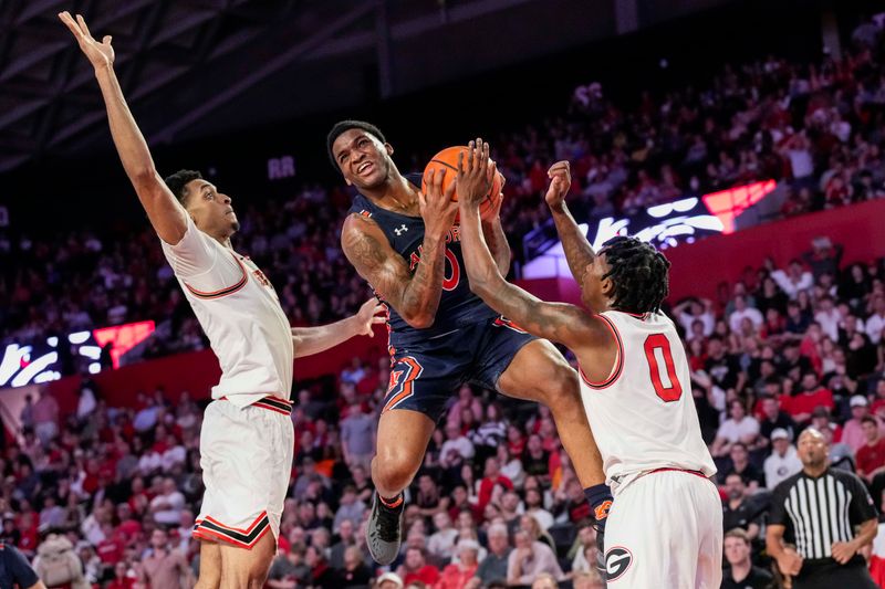 Jan 4, 2023; Athens, Georgia, USA; Auburn Tigers guard K.D. Johnson (0) tries to get past Georgia Bulldogs guard Terry Roberts (0) during the first half at Stegeman Coliseum. Mandatory Credit: Dale Zanine-USA TODAY Sports