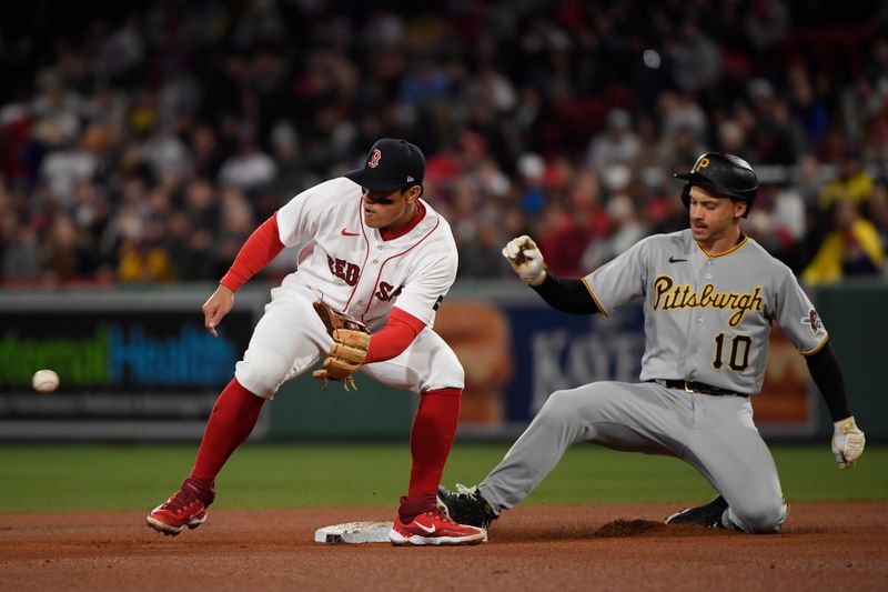 Apr 4, 2023; Boston, Massachusetts, USA;  Pittsburgh Pirates center fielder Bryan Reynolds (10) safely slides into second base before the tag of Boston Red Sox second baseman Yu Chang (20) during the fifth inning at Fenway Park. Mandatory Credit: Bob DeChiara-USA TODAY Sports