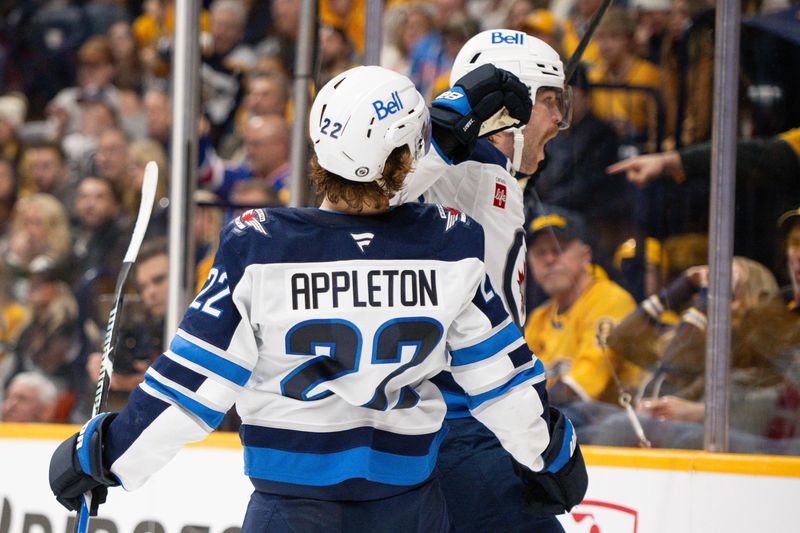 Nov 23, 2024; Nashville, Tennessee, USA;  Winnipeg Jets center Adam Lowry (17) celebrates his goal with center Mason Appleton (22) against the Nashville Predators during the second period at Bridgestone Arena. Mandatory Credit: Steve Roberts-Imagn Images