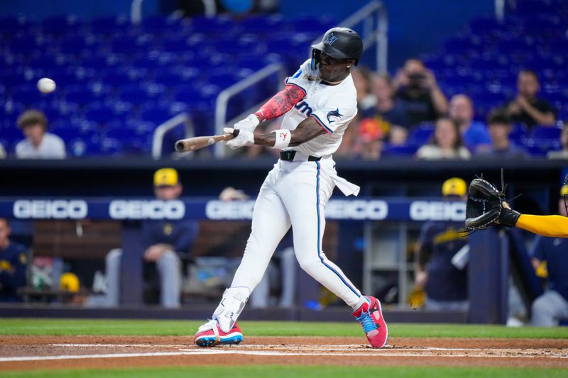 May 22, 2024; Miami, Florida, USA; Miami Marlins outfielder Jazz Chisholm Jr. (2) hits a home run against the Milwaukee Brewers during the first inning at loanDepot Park. Mandatory Credit: Rich Storry-USA TODAY Sports