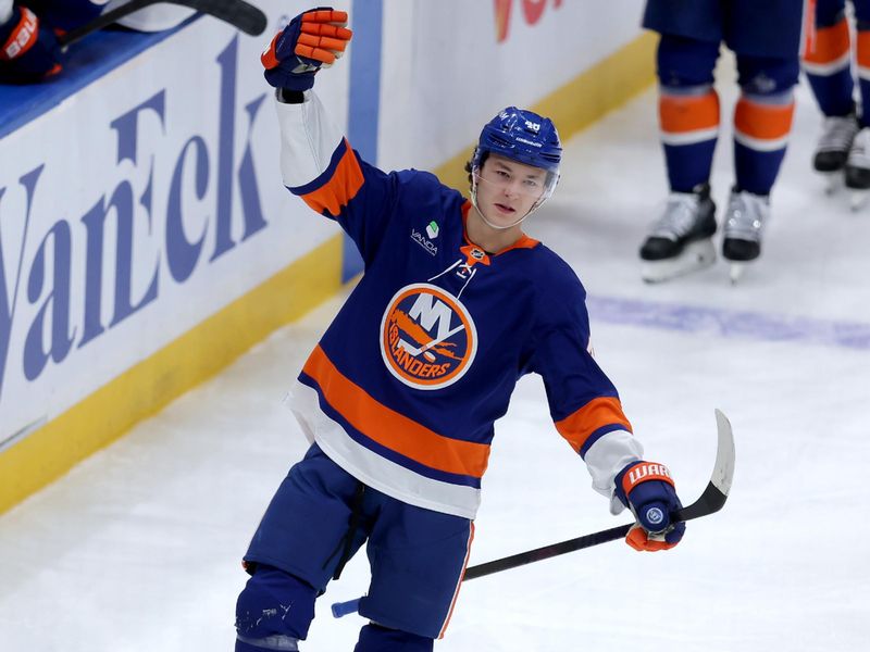 Oct 11, 2025; Elmont, New York, USA; New York Islanders defenseman Matthew Schaefer (48) celebrates his goal against the Washington Capitals during the third period at UBS Arena. The goal was the first of his NHL career. Mandatory Credit: Brad Penner-Imagn Images