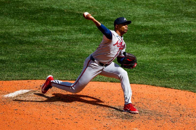 May 1, 2024; Seattle, Washington, USA; Atlanta Braves relief pitcher Raisel Iglesias (26) throws against the Seattle Mariners during the ninth inning at T-Mobile Park. Mandatory Credit: Joe Nicholson-USA TODAY Sports