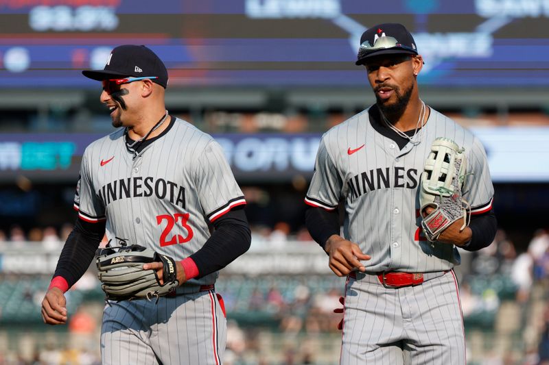 Jul 26, 2024; Detroit, Michigan, USA; Minnesota Twins outfielder Byron Buxton (25) and third baseman Royce Lewis (23) return to the dugout after the first inning of the game against the Detroit Tigers at Comerica Park. Mandatory Credit: Brian Bradshaw Sevald-USA TODAY Sports