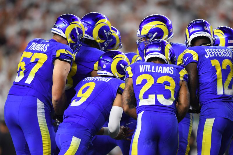 Los Angeles Rams quarterback Matthew Stafford (9) huddles with teammates during an NFL football game against the Cincinnati Bengals on Monday, Sept. 25, 2023, in Cincinnati. (AP Photo/Emilee Chinn)