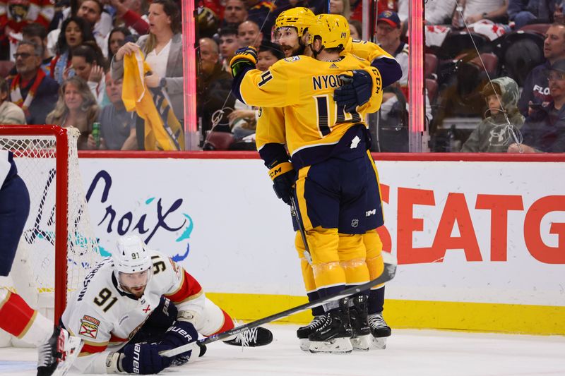 Mar 21, 2024; Sunrise, Florida, USA; Nashville Predators center Gustav Nyquist (14) celebrates with left wing Filip Forsberg (9) after scoring against the Florida Panthers during the first period at Amerant Bank Arena. Mandatory Credit: Sam Navarro-USA TODAY Sports