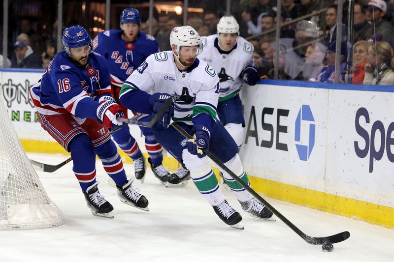 Dec 16, 2025; New York, New York, USA; Vancouver Canucks defenseman Marcus Pettersson (29) plays the puck against New York Rangers center Vincent Trocheck (16) during the second period at Madison Square Garden. Mandatory Credit: Brad Penner-Imagn Images