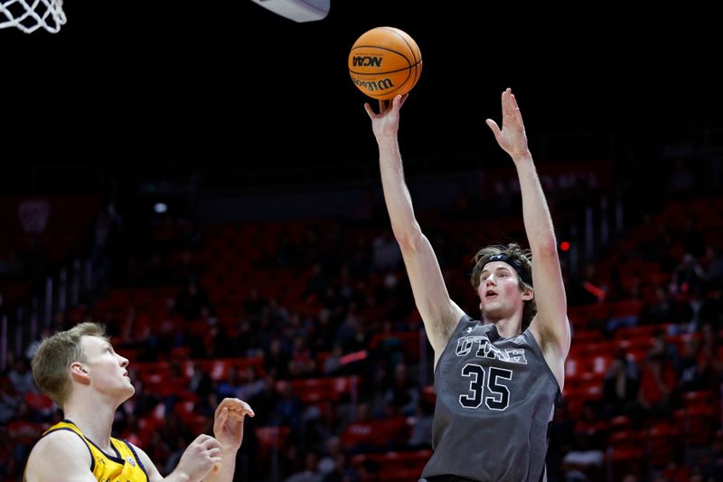 Feb 5, 2023; Salt Lake City, Utah, USA; Utah Utes center Branden Carlson (35) shoots over California Golden Bears forward Lars Thiemann (21) in the second half at Jon M. Huntsman Center. Mandatory Credit: Jeffrey Swinger-USA TODAY Sports