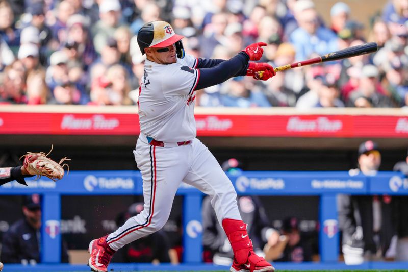 Apr 4, 2024; Minneapolis, Minnesota, USA; Minnesota Twins catcher Christian Vazquez (8) hits a single during the second inning against the Cleveland Guardians at Target Field. Mandatory Credit: Jordan Johnson-USA TODAY Sports