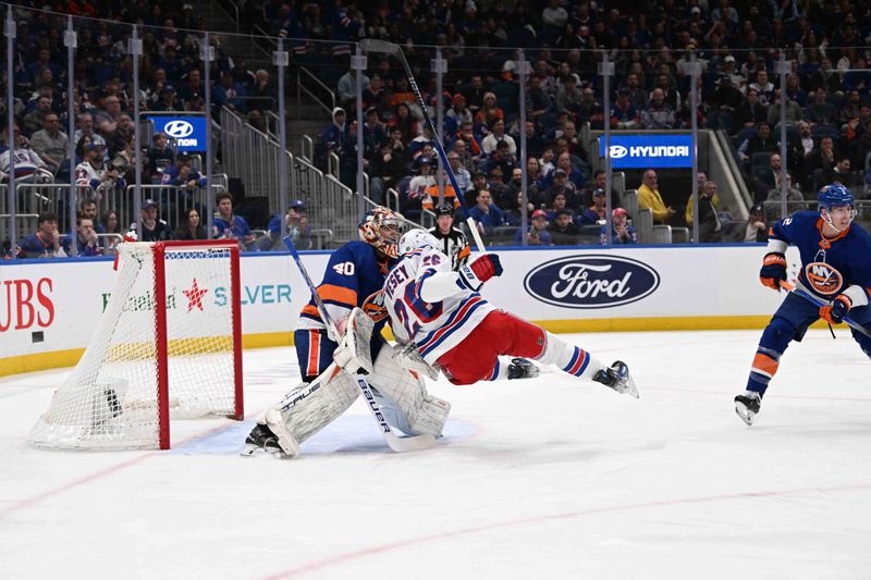 Apr 9, 2024; Elmont, New York, USA; New York Rangers left wing Jimmy Vesey (26) falls in front of New York Islanders goaltender Semyon Varlamov (40) during the third period at UBS Arena. Mandatory Credit: Dennis Schneidler-USA TODAY Sports