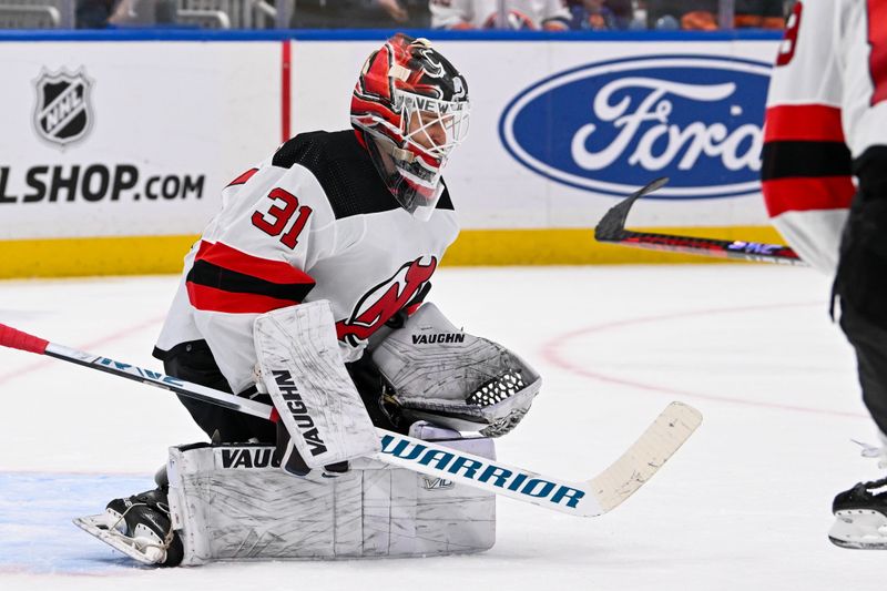 Mar 24, 2024; Elmont, New York, USA;  New Jersey Devils goaltender Kaapo Kahkonen (31) makes a save against the New York Islanders during the second period at UBS Arena. Mandatory Credit: Dennis Schneidler-USA TODAY Sports