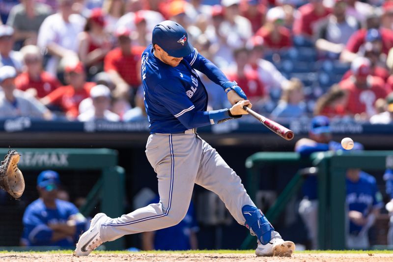 May 8, 2024; Philadelphia, Pennsylvania, USA; Toronto Blue Jays catcher Danny Jansen (9) hits a double during the sixth inning against the Philadelphia Phillies at Citizens Bank Park. Mandatory Credit: Bill Streicher-USA TODAY Sports