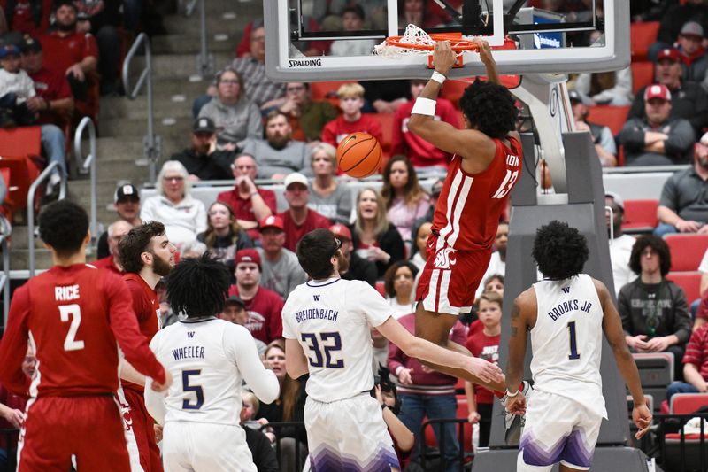 Mar 7, 2024; Pullman, Washington, USA; Washington State Cougars forward Isaac Jones (13) dunks the ball against Washington Huskies forward Wilhelm Breidenbach (32) in the second half at Friel Court at Beasley Coliseum. Washington Huskies won 74-68. Mandatory Credit: James Snook-USA TODAY Sports