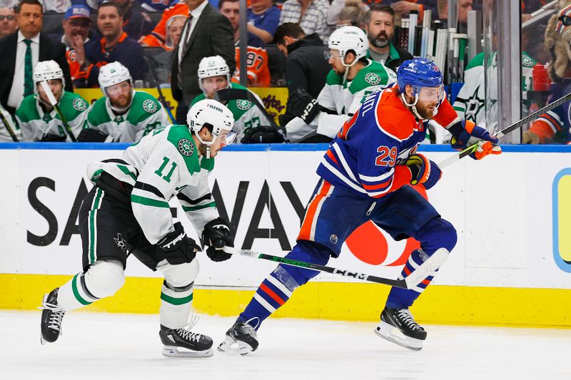 Jun 2, 2024; Edmonton, Alberta, CAN; Dallas Star forward Logan Stankoven (11) and Edmonton Oilers forward Leon Draisaitl (29) chase a loose puck during the third period in game six of the Western Conference Final of the 2024 Stanley Cup Playoffs at Rogers Place. Mandatory Credit: Perry Nelson-USA TODAY Sports