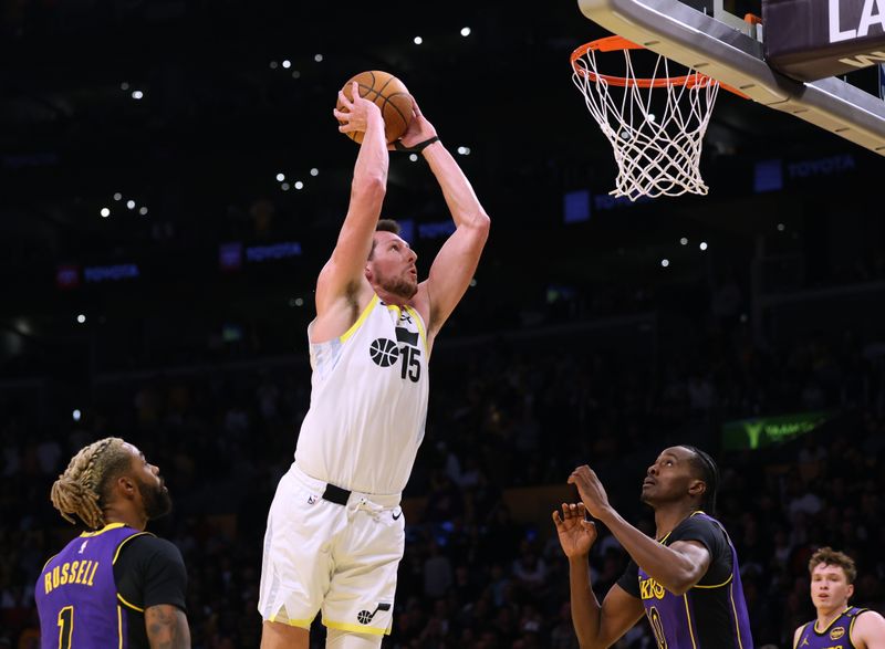 LOS ANGELES, CALIFORNIA - NOVEMBER 19: Drew Eubanks #15 of the Utah Jazz dunks between Christian Koloko #10 and D'Angelo Russell #1 of the Los Angeles Lakers during a 124-118 loss to the Lakers at Crypto.com Arena on November 19, 2024 in Los Angeles, California. (Photo by Harry How/Getty Images) NOTE TO USER: User expressly acknowledges and agrees that, by downloading and or using this photograph, User is consenting to the terms and conditions of the Getty Images License Agreement.  (Photo by Harry How/Getty Images)