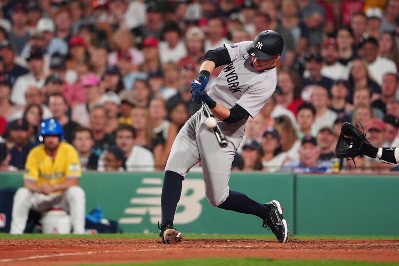 Jul 27, 2024; Boston, Massachusetts, USA; New York Yankees first baseman Ben Rice (93) hits a sacrifice fly ball against the Boston Red Sox during the seventh inning at Fenway Park. Mandatory Credit: Gregory Fisher-USA TODAY Sports