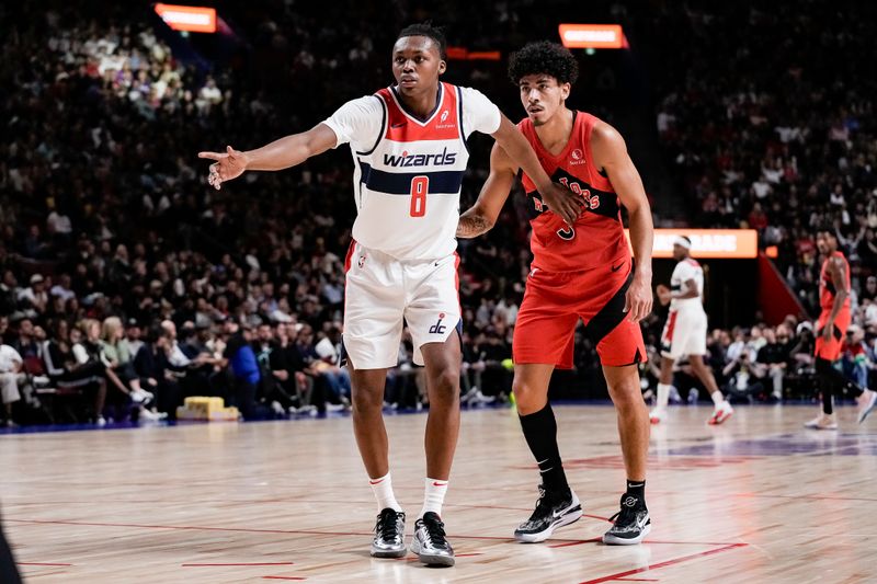 MONTREAL, CANADA - OCTOBER 6:  Carlton Carrington #8 of the Washington Wizards defends DJ Carton #3 of the Toronto Raptors during the game on October 6, 2024 at the Bell Centre in Montreal, Quebec, Canada.  NOTE TO USER: User expressly acknowledges and agrees that, by downloading and or using this Photograph, user is consenting to the terms and conditions of the Getty Images License Agreement.  Mandatory Copyright Notice: Copyright 2024 NBAE (Photo by Jordan Jones/NBAE via Getty Images)