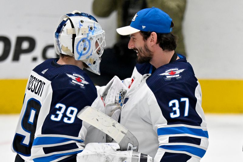 Apr 11, 2024; Dallas, Texas, USA; Winnipeg Jets goaltender Laurent Brossoit (39) and goaltender Connor Hellebuyck (37) celebrate on the ice after the Jets defeat the Dallas Stars at the American Airlines Center. Mandatory Credit: Jerome Miron-USA TODAY Sports