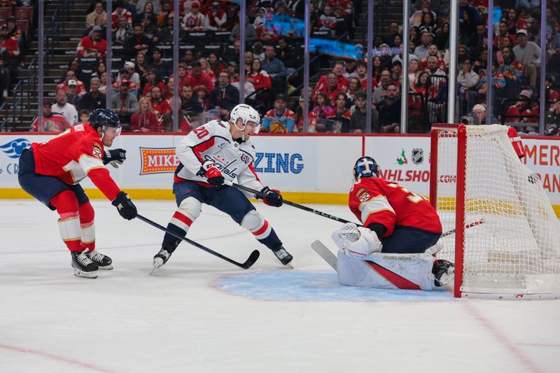 Nov 25, 2024; Sunrise, Florida, USA; Washington Capitals center Lars Eller (20) scores against Florida Panthers goaltender Spencer Knight (30) during the first period at Amerant Bank Arena. Mandatory Credit: Sam Navarro-Imagn Images