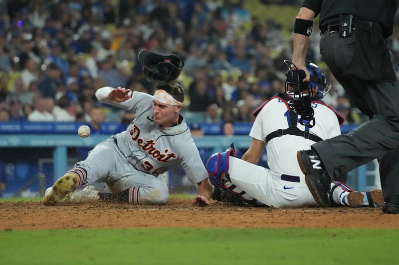 Sep 20, 2023; Los Angeles, California, USA; Detroit Tigers right fielder Kerry Carpenter (30) slides into home plate to beat a throw to Los Angeles Dodgers catcher Austin Barnes (15) to score in the eighth inning at Dodger Stadium. Mandatory Credit: Kirby Lee-USA TODAY Sports