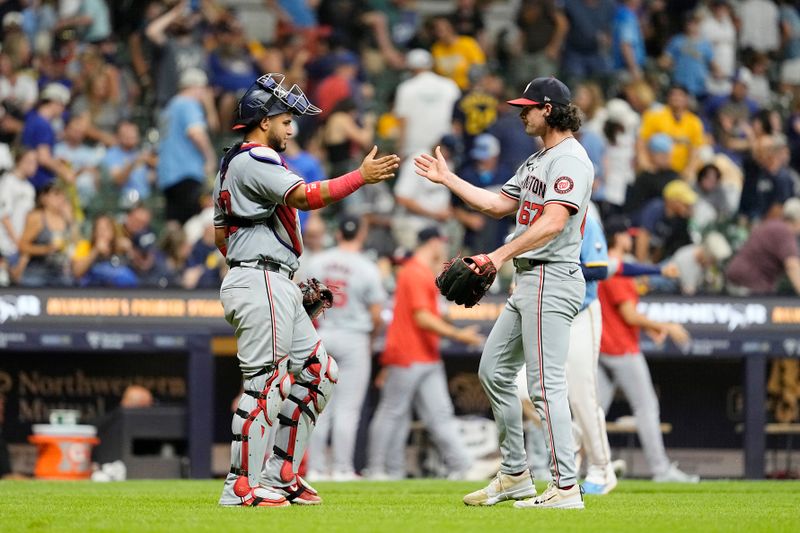 Jul 12, 2024; Milwaukee, Wisconsin, USA;  Washington Nationals pitcher Kyle Finnegan (67) greets catcher Keibert Ruiz (20) following the game against the Milwaukee Brewers at American Family Field. Mandatory Credit: Jeff Hanisch-USA TODAY Sports