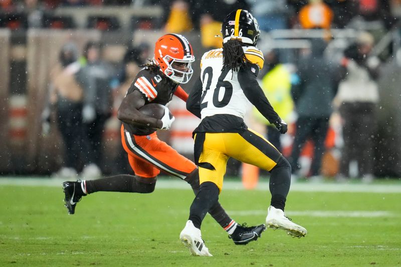 Cleveland Browns wide receiver Jerry Jeudy (3) carries against Pittsburgh Steelers cornerback Donte Jackson (26) in the first half of an NFL football game, Thursday, Nov. 21, 2024, in Cleveland. (AP Photo/Sue Ogrocki)