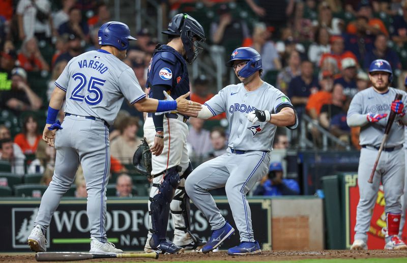 Apr 2, 2024; Houston, Texas, USA; Toronto Blue Jays left fielder Davis Schneider (36) celebrates with left fielder Daulton Varsho (25) after hitting a home run during the ninth inning against the Houston Astros at Minute Maid Park. Mandatory Credit: Troy Taormina-USA TODAY Sports