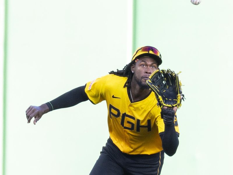 May 9, 2025; Pittsburgh, Pennsylvania, USA; Pittsburgh Pirates center fielder Oneil Cruz (15) reaches to catch a fly ball for the third out in the second inning against the Atlanta Braves at PNC Park. Mandatory Credit: Scott Galvin-Imagn Images