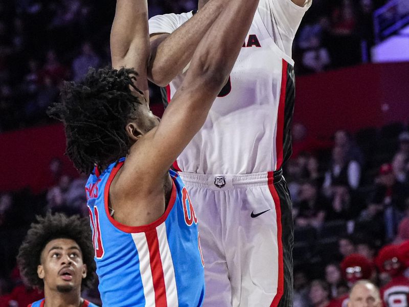 Feb 7, 2023; Athens, Georgia, USA; Georgia Bulldogs center Frank Anselem (5) shoots over Mississippi Rebels forward Jayveous McKinnis (00) during the second half at Stegeman Coliseum. Mandatory Credit: Dale Zanine-USA TODAY Sports