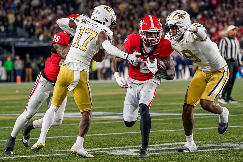 Nov 25, 2023; Atlanta, Georgia, USA; Georgia Bulldogs wide receiver Dominic Lovett (6) runs against Georgia Tech Yellow Jackets defensive back Rodney Shelley (17) and defensive lineman Kyle Kennard (9) during the second half at Hyundai Field. Mandatory Credit: Dale Zanine-USA TODAY Sports