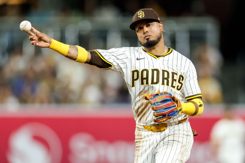 Sep 13, 2025; San Diego, California, USA; San Diego Padres second baseman Luis Arraez (4) throws to first base for an out during the seventh inning against the Colorado Rockies at Petco Park. Mandatory Credit: David Frerker-Imagn Images