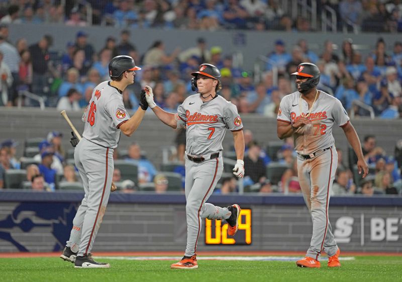 Aug 7, 2024; Toronto, Ontario, CAN; Baltimore Orioles second baseman Jackson Holliday (7) hits a two run home run and celebrates with  third baseman Coby Mayo (16) against the Toronto Blue Jays during the seventh inning at Rogers Centre. Mandatory Credit: Nick Turchiaro-USA TODAY Sports