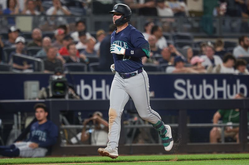 May 21, 2024; Bronx, New York, USA; Seattle Mariners first baseman Ty France (23) scores a run after hitting a solo home run against the New York Yankees during the seventh inning at Yankee Stadium. Mandatory Credit: Vincent Carchietta-USA TODAY Sports