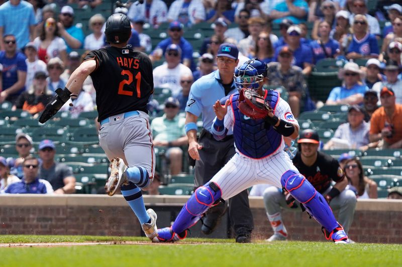 Jun 18, 2023; Chicago, Illinois, USA; Chicago Cubs catcher Miguel Amaya (6) prepares to tag out Baltimore Orioles left fielder Austin Hays (21) at home plate during the first inning at Wrigley Field. Mandatory Credit: David Banks-USA TODAY Sports