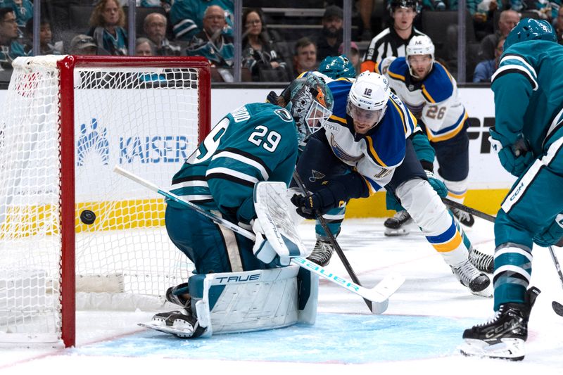 Oct 10, 2024; San Jose, California, USA;  St. Louis Blues center Radek Faksa (12) shoots the puck past San Jose Sharks goaltender Mackenzie Blackwood (29) during the third period at SAP Center at San Jose. Mandatory Credit: Stan Szeto-Imagn Images