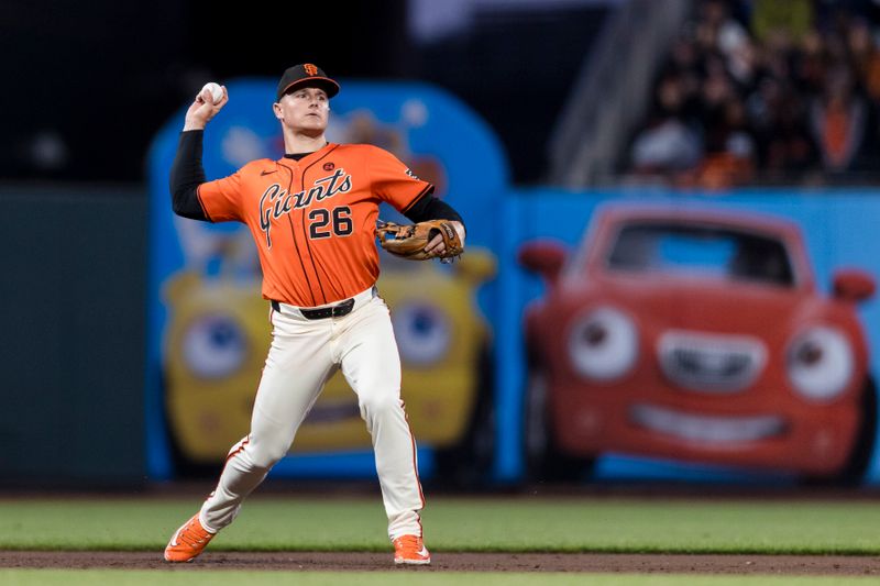 Aug 30, 2024; San Francisco, California, USA; San Francisco Giants third baseman Matt Chapman (26) throws to first base for an out against the Miami Marlins during the third inning at Oracle Park. Mandatory Credit: John Hefti-USA TODAY Sports