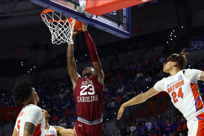 Jan 25, 2023; Gainesville, Florida, USA; South Carolina Gamecocks forward Gregory Jackson II (23) shoots over Florida Gators guard Will Richard (5) and guard Riley Kugel (24) during the first half at Exactech Arena at the Stephen C. O'Connell Center. Mandatory Credit: Kim Klement-USA TODAY Sports