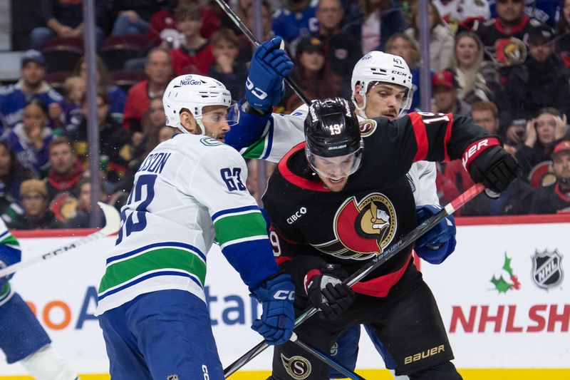 Nov 23, 2024; Ottawa, Ontario, CAN; Ottawa Senators right wing Drake Batherson (19) battles for position with Vancouver Canucks center Max Sasson (63) and defenseman Noah Juulsen (47) in the first period at the Canadian Tire Centre. Mandatory Credit: Marc DesRosiers-Imagn Images