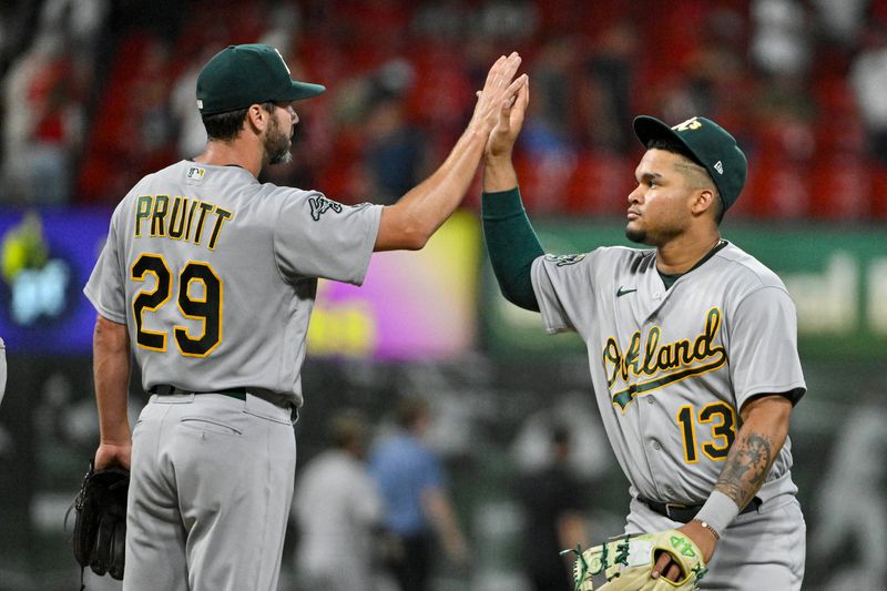 Aug 16, 2023; St. Louis, Missouri, USA;  Oakland Athletics third baseman Jordan Diaz (13) and relief pitcher Austin Pruitt (29) celebrate after the Athletics defeated the St. Louis Cardinals at Busch Stadium. Mandatory Credit: Jeff Curry-USA TODAY Sports