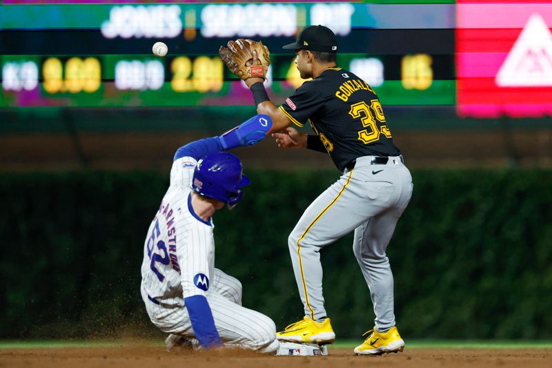 Sep 2, 2024; Chicago, Illinois, USA; Chicago Cubs outfielder Pete Crow-Armstrong (52) steals second base as Pittsburgh Pirates second baseman Nick Gonzales (39) waits for the ball during the fifth inning at Wrigley Field. Mandatory Credit: Kamil Krzaczynski-USA TODAY Sports