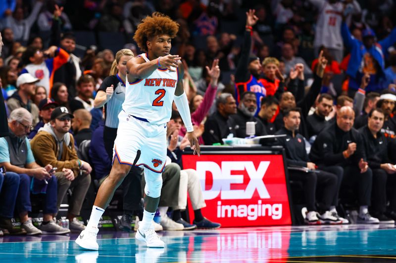 CHARLOTTE, NORTH CAROLINA - NOVEMBER 29: Miles McBride #2 of the New York Knicks points after making a basket during the first half of a basketball game against the Charlotte Hornets at Spectrum Center on November 29, 2024 in Charlotte, North Carolina. NOTE TO USER: User expressly acknowledges and agrees that, by downloading and or using this photograph, User is consenting to the terms and conditions of the Getty Images License Agreement. (Photo by David Jensen/Getty Images)