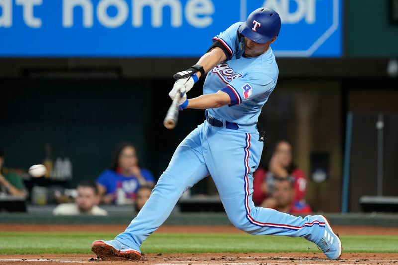 Aug 20, 2023; Arlington, Texas, USA; Texas Rangers shortstop Corey Seager (5) singles against the Milwaukee Brewers during the first inning at Globe Life Field. Mandatory Credit: Jim Cowsert-USA TODAY Sports